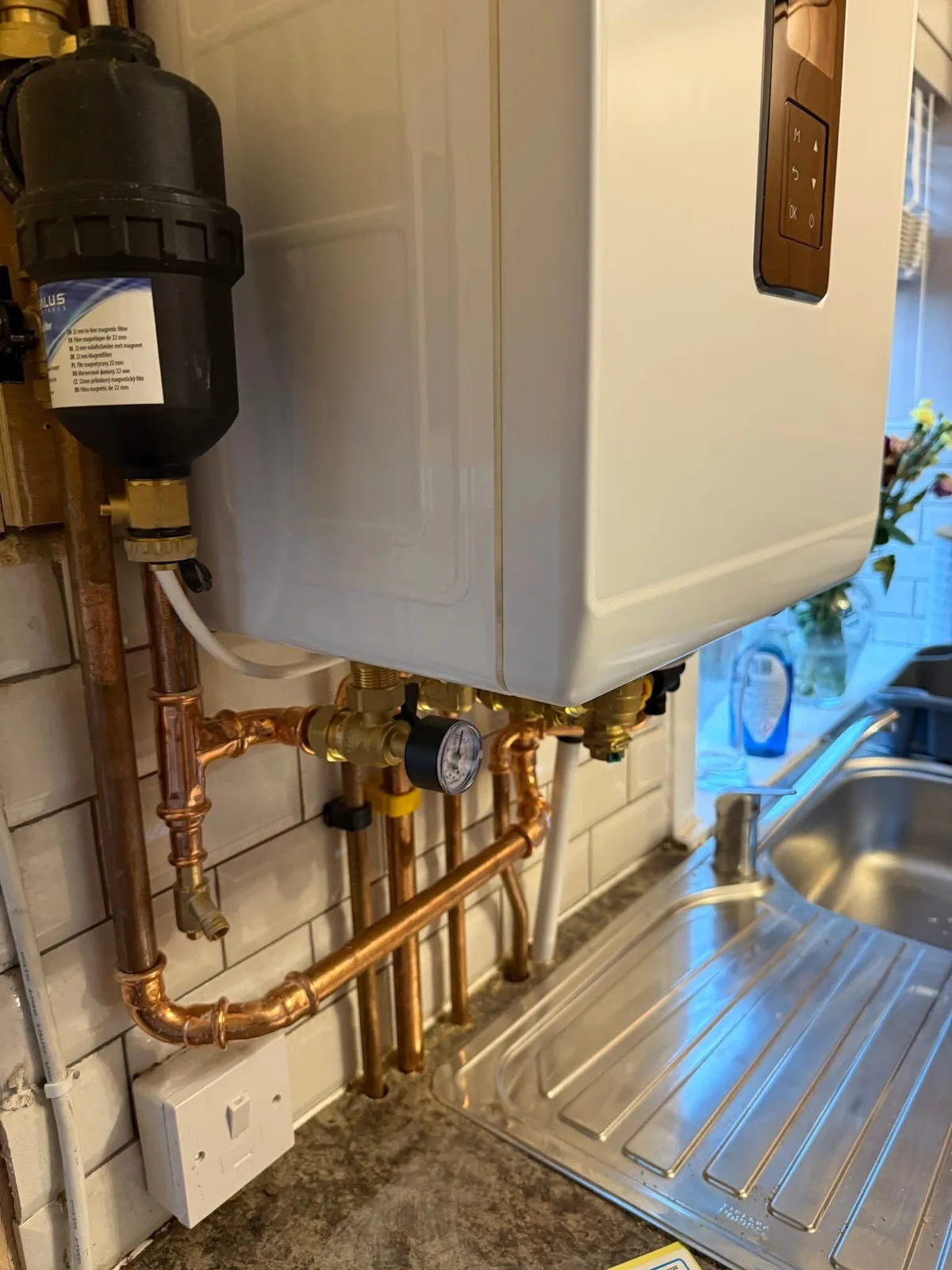 Copper pipework beneath a boiler